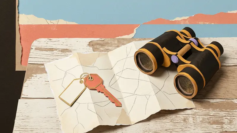 A brass key and folded map on a wooden table looking toward a distant, blurred ocean horizon.