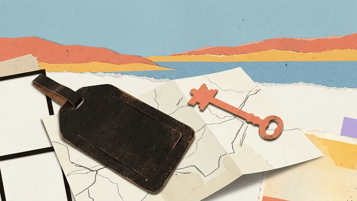 A brass key and a blank luggage tag rest on a folded paper map against a layered paper horizon.