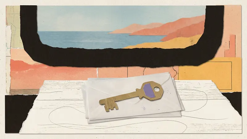 A brass key and vellum envelopes on a wooden table by a window.