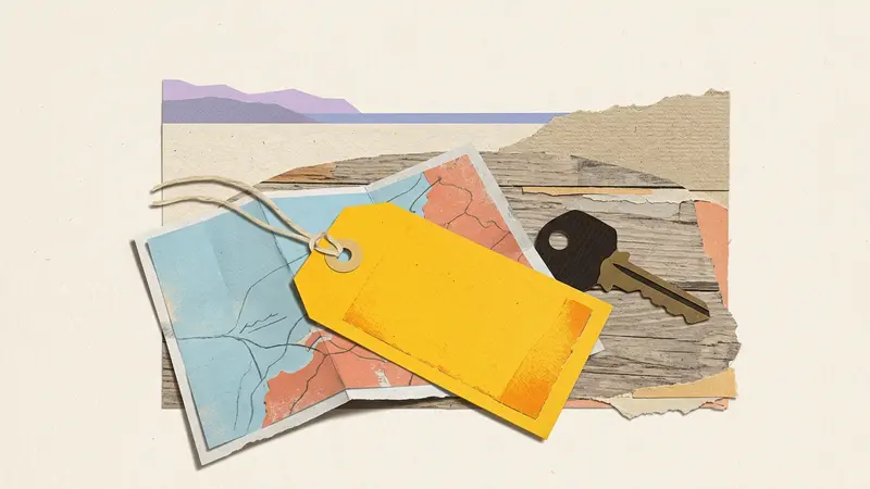 Papercraft of a yellow luggage tag, a folded map, and a brass key resting on a wooden tabletop.