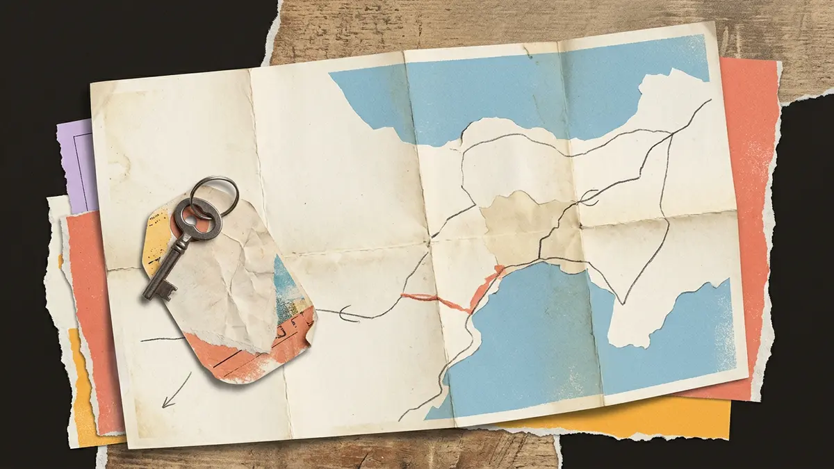 Papercraft scene of a folded map, a vintage key, and a blank luggage tag on a table.