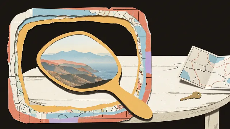 Papercraft of a mountain reflection inside a mirror frame on a wooden table.